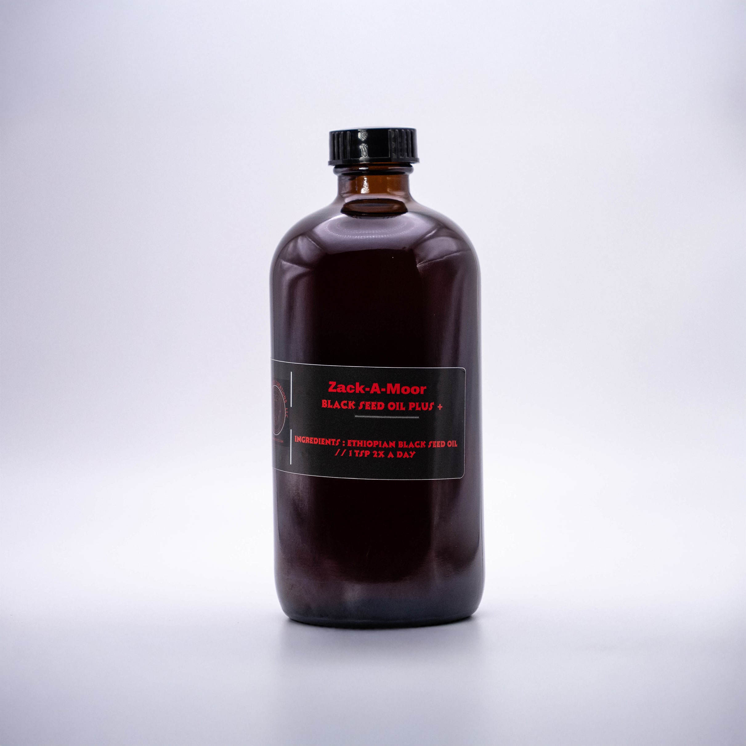Zack-A-Moor Black Seed Oil Plus 16oz bottle with a dark label and sleek design, placed on a light background.