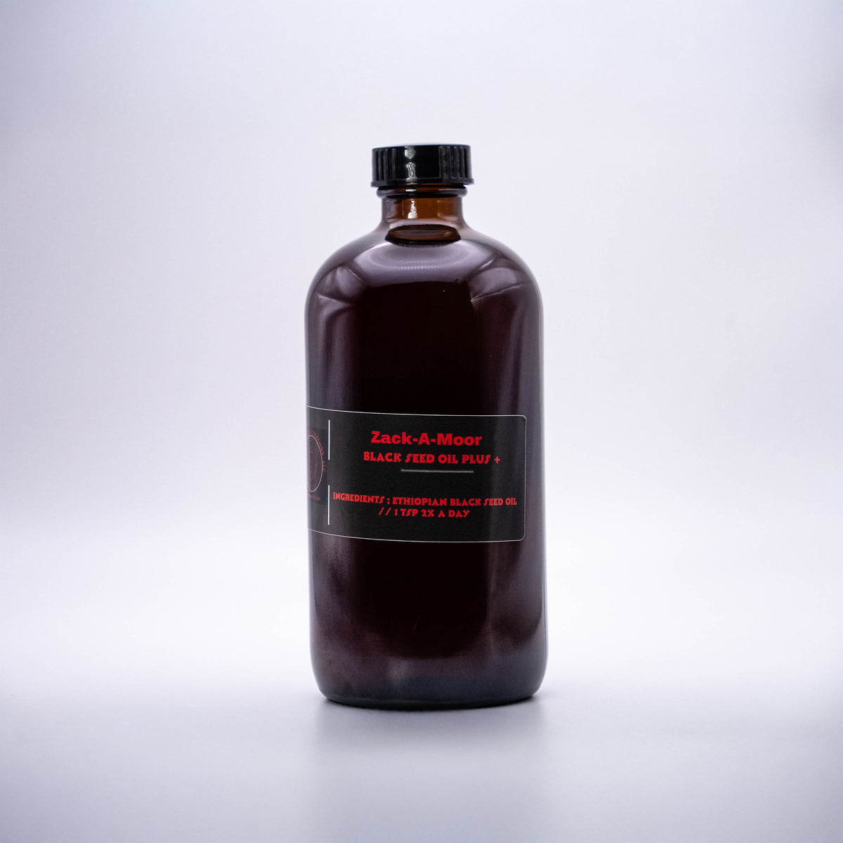 Zack-A-Moor Black Seed Oil Plus 16oz bottle with a dark label and sleek design, placed on a light background.
